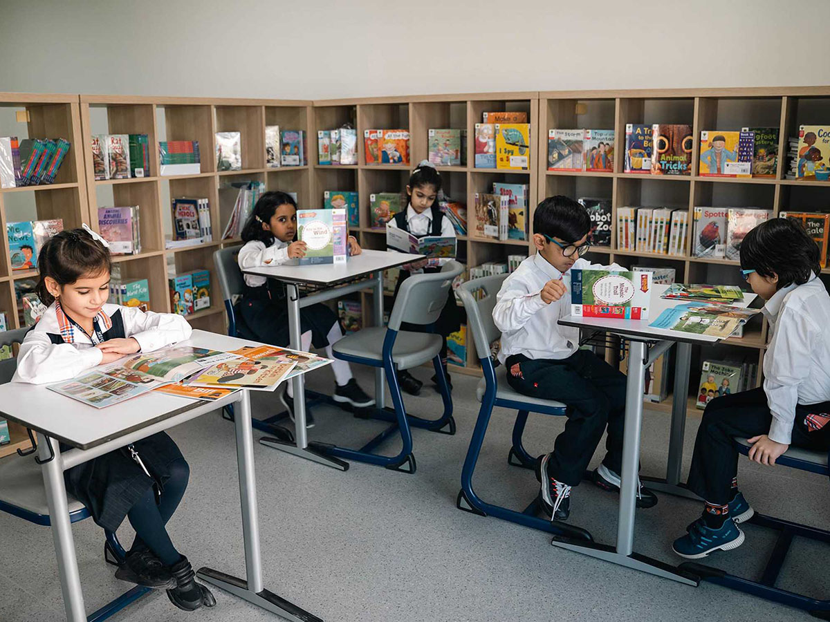 ISK students reading books in the library